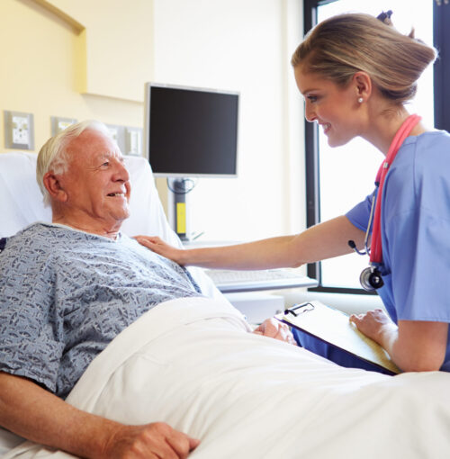 Nurse,Talking,To,Senior,Male,Patient,In,Hospital,Room Nurse,Talking,To,Senior,Male,Patient,In,Hospital,Room